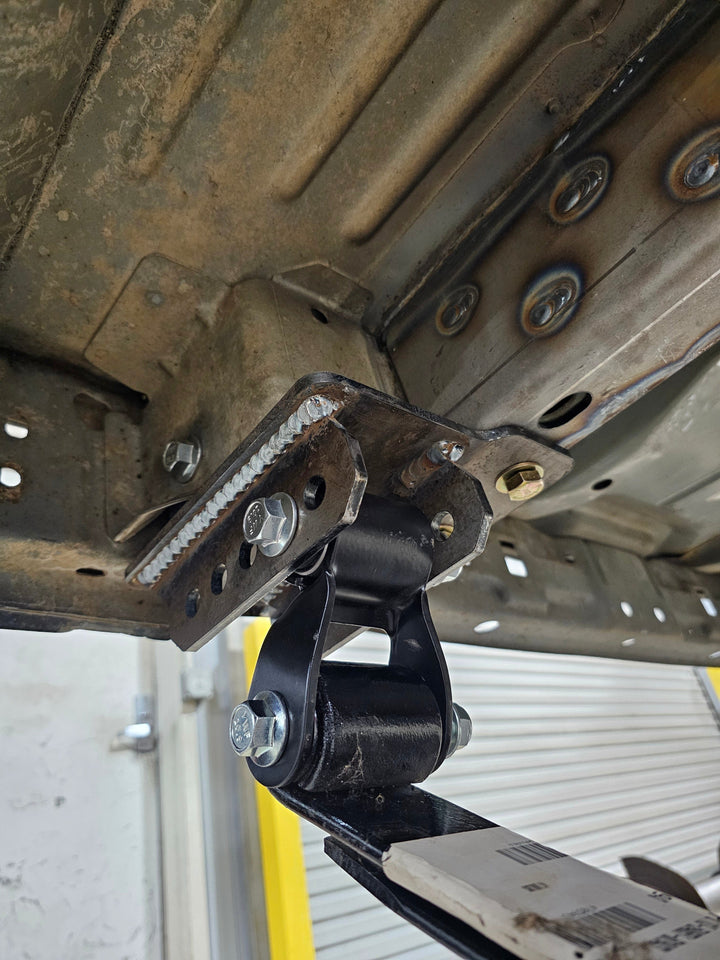 Undercarriage with suspension components attached.