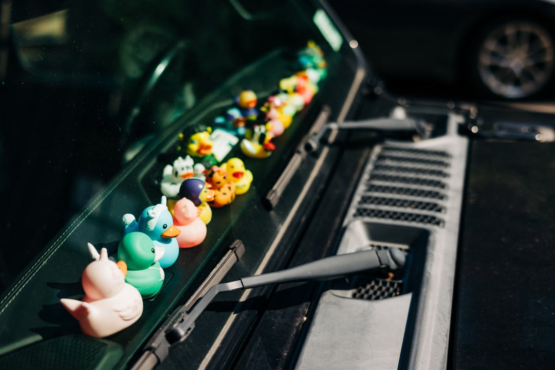 Jeep with a row of colorful ducks on the dash, prompting the question, ‘Why do Jeep owners have ducks?