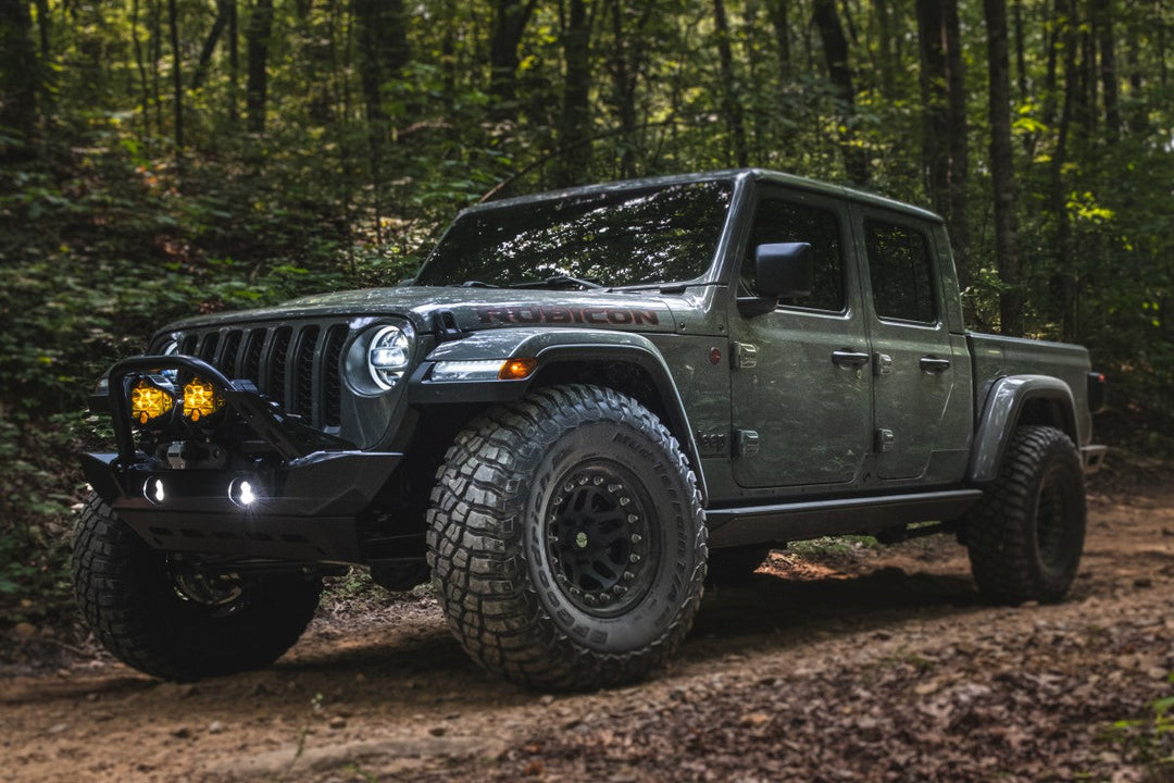 Modified Jeep Gladiator Rubicon on a wooded trail in a Jeep Gladiator Mojave vs Rubicon comparison