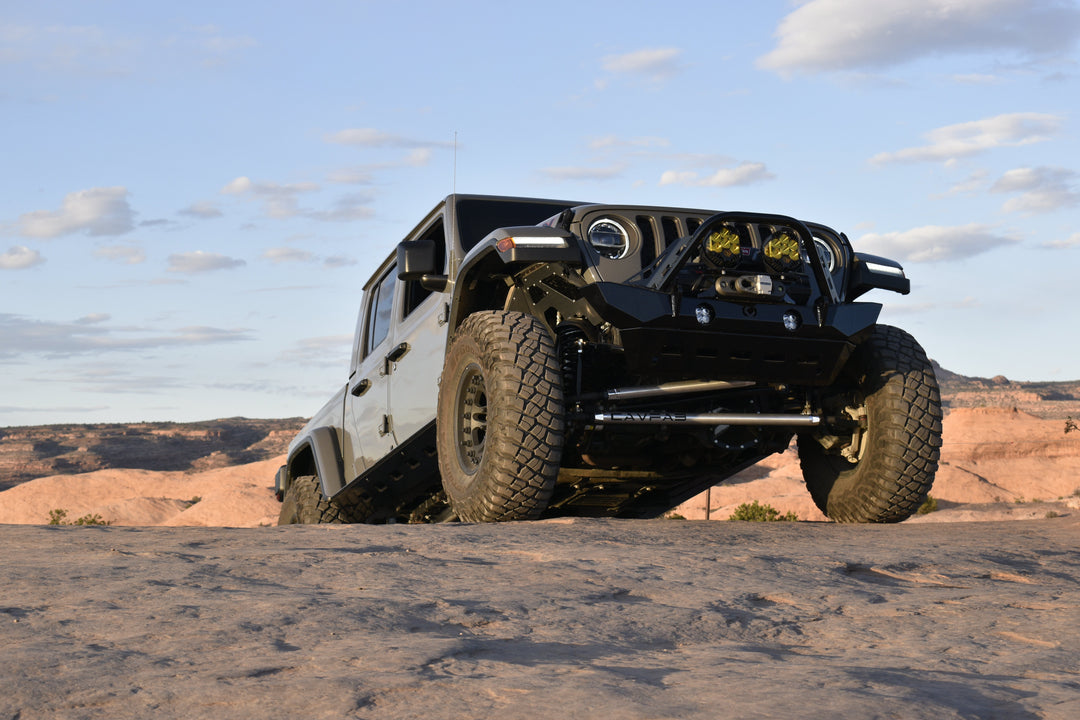 Modified Jeep Gladiator tackling slickrock terrain in a guide to the best Jeep models for off-road adventures