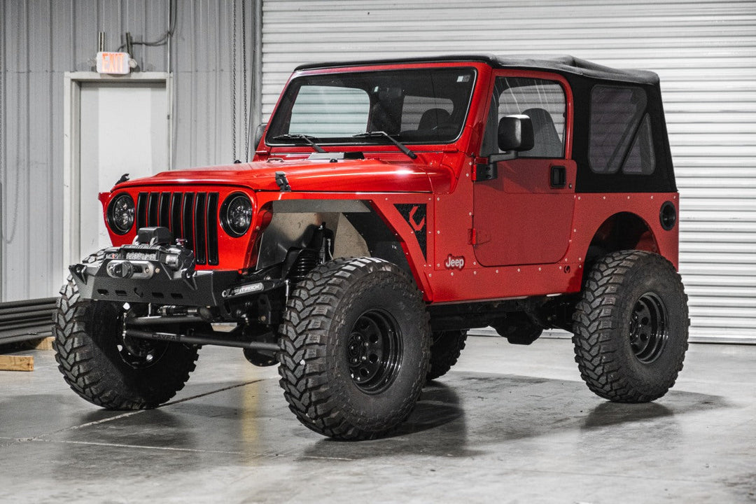 Red Jeep TJ being prepped in body shop for the best Jeep TJ upgrades.