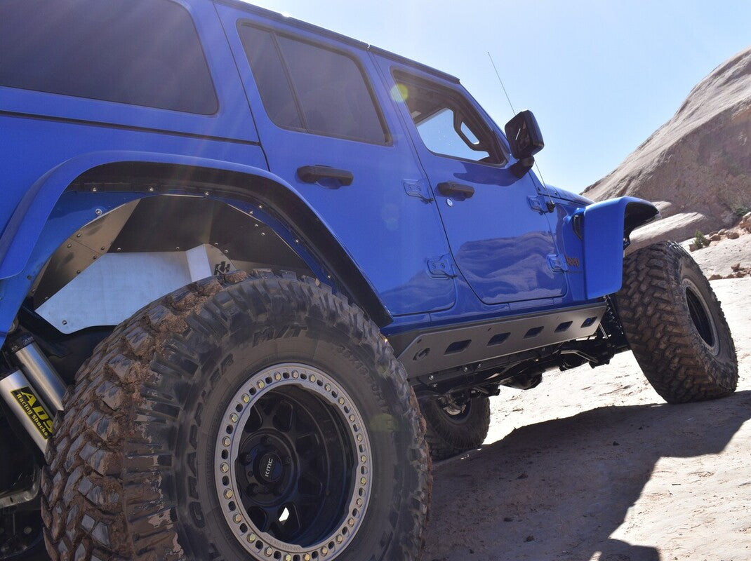 closeup of the best tires for Jeep Wrangler on a blue off-road Jeep