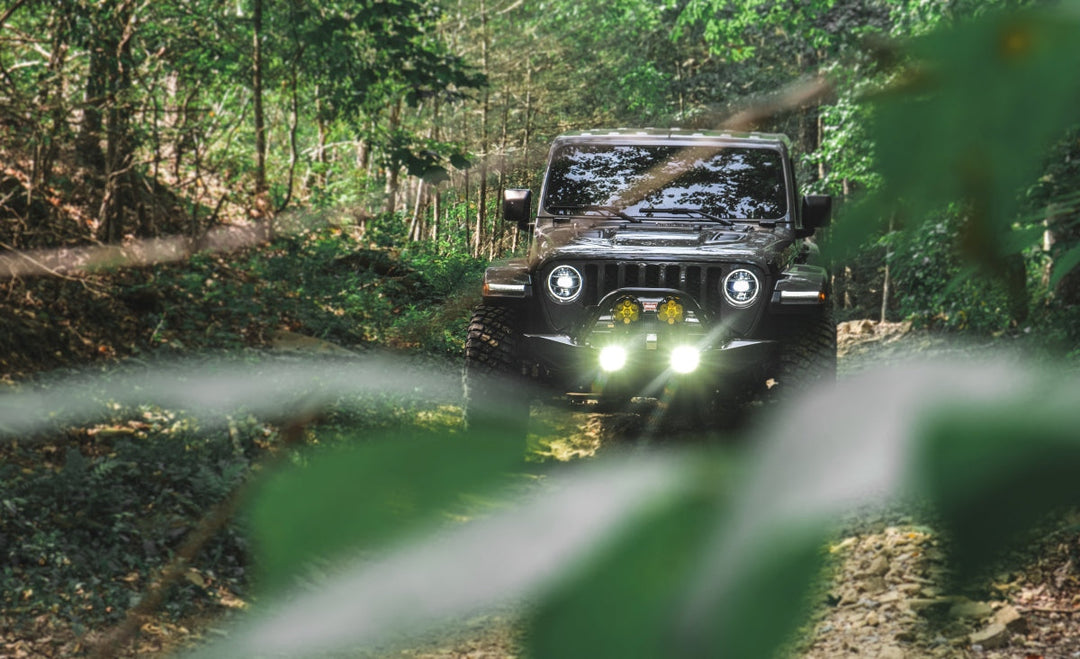 Black four-door Jeep Wrangler Rubicon parked on a grassy trail, illustrating the best and worst years for Jeep Wrangler